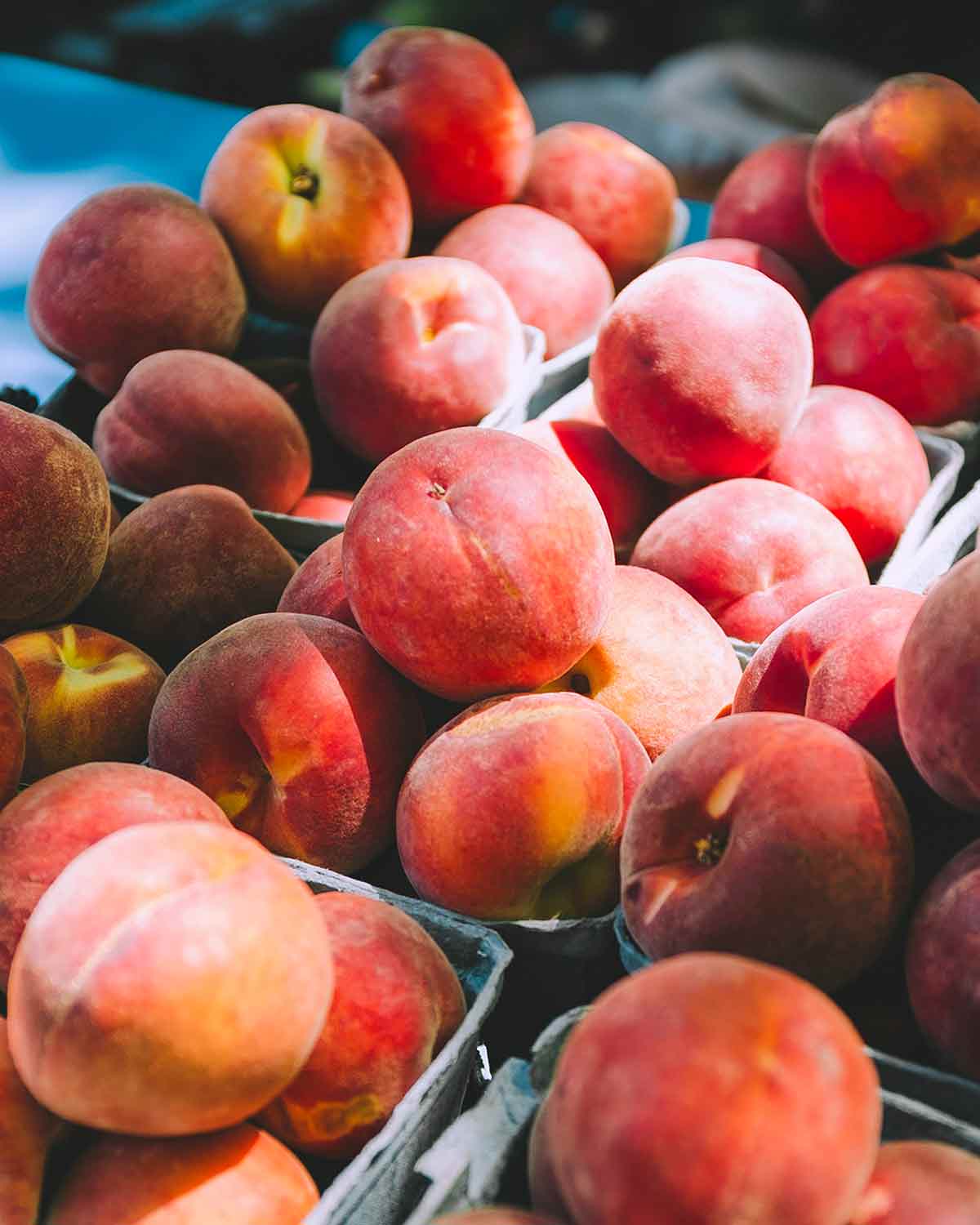 Small baskets of perfectly ripe peaches.