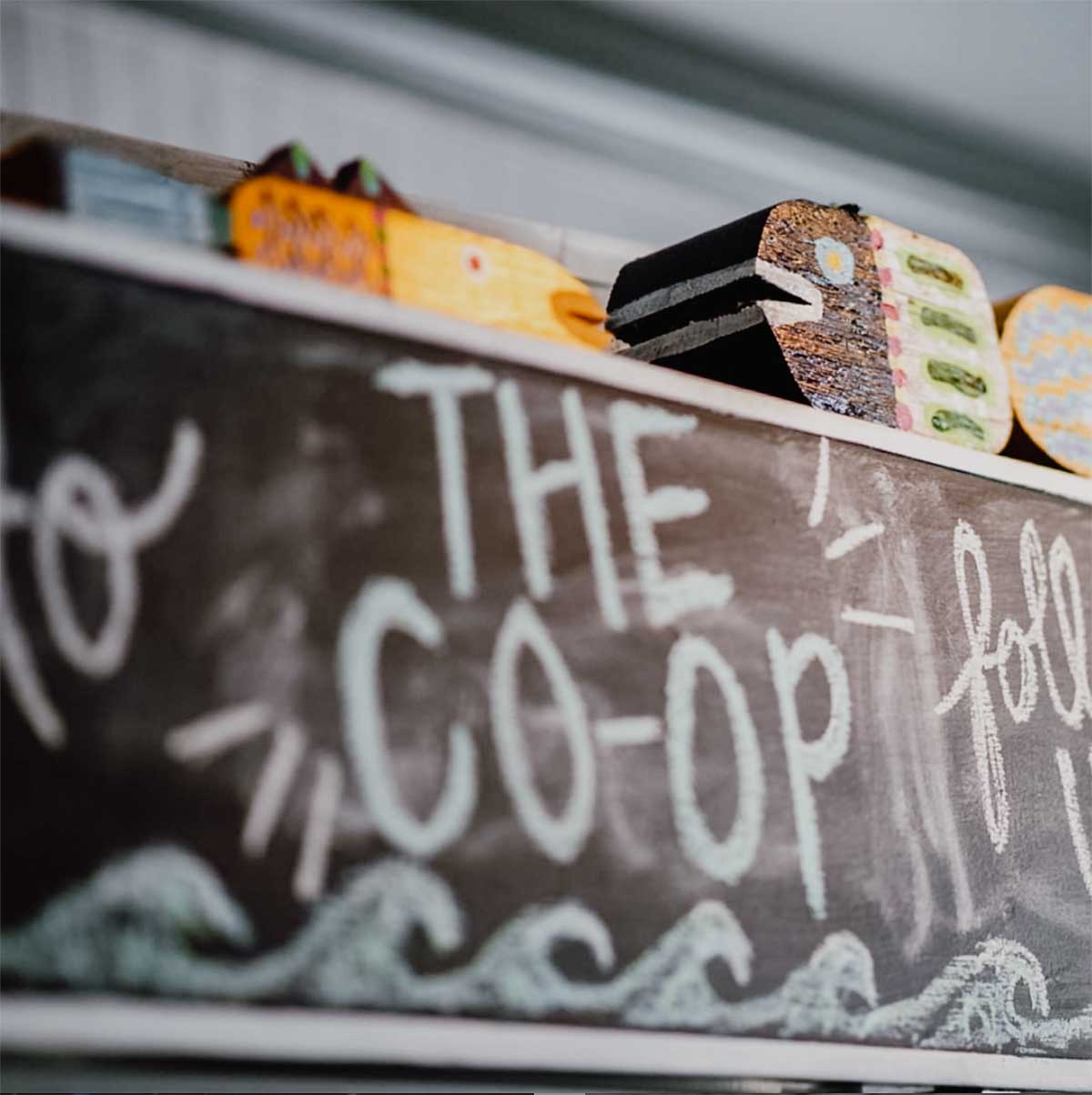A chalk sign with THE CO-OP written on it for the podcast, Talking With My Mouth Full, Ep. 30: Jess Patterson: Frosé King.