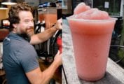An image of Jess Patterson at a Frosé machine and a tall plastic cup filled with Frosé for the podcast, Talking With My Mouth Full, Ep. 30: Jess Patterson: Frosé King