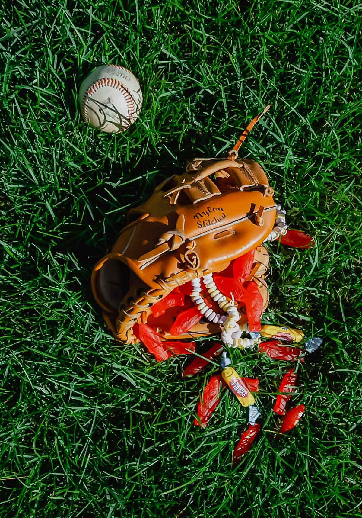A baseball glove filled with candy and a baseball lying beside it as an illustration of David's problem with balls.