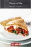 A wedge of tomato pie on a white plate with a fork in the background.