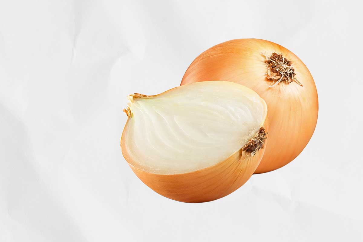 A whole onion and a cut onion half which you can use if you want to know how to clean your grill.