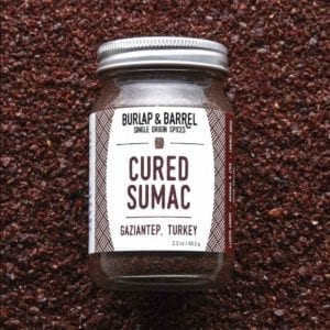 Cured Sumac in jar on bed of sumac.