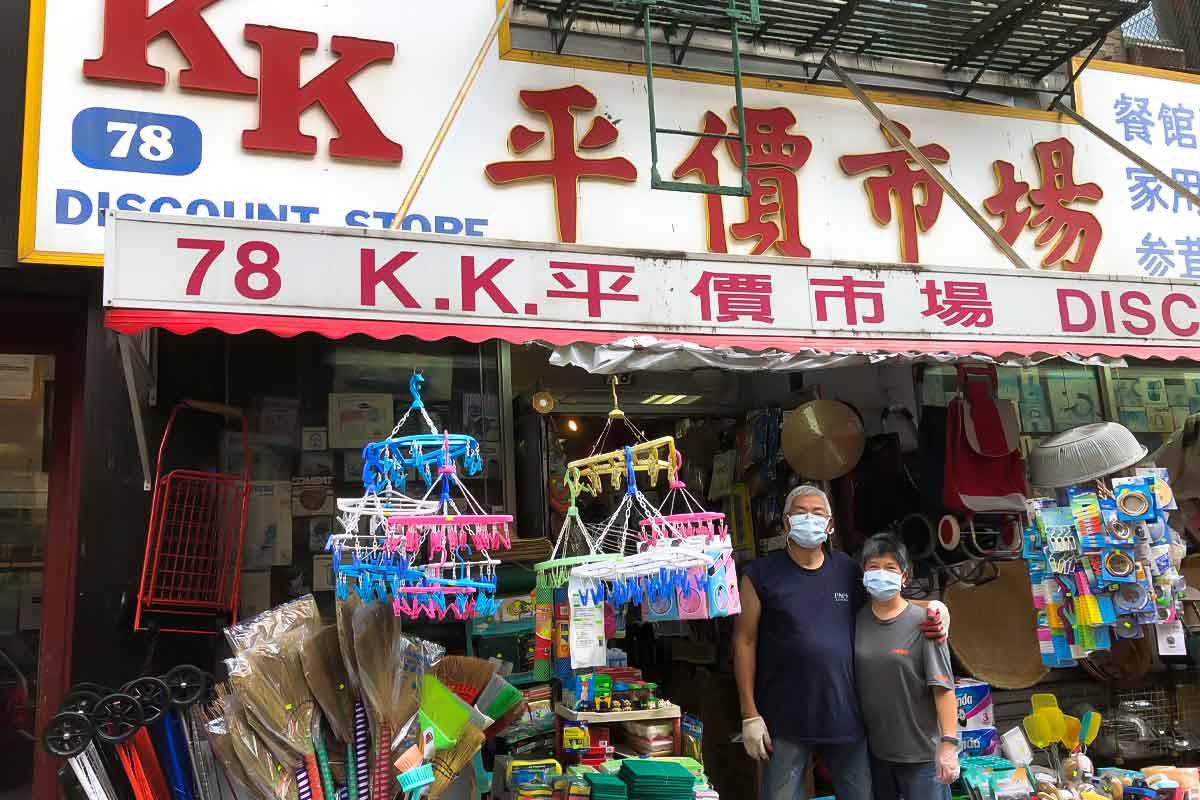 The owners posing in front of the KK Discount Store for the podcast Ep. 31: Grace Young: Coronavirus: Chinatown Stories.
