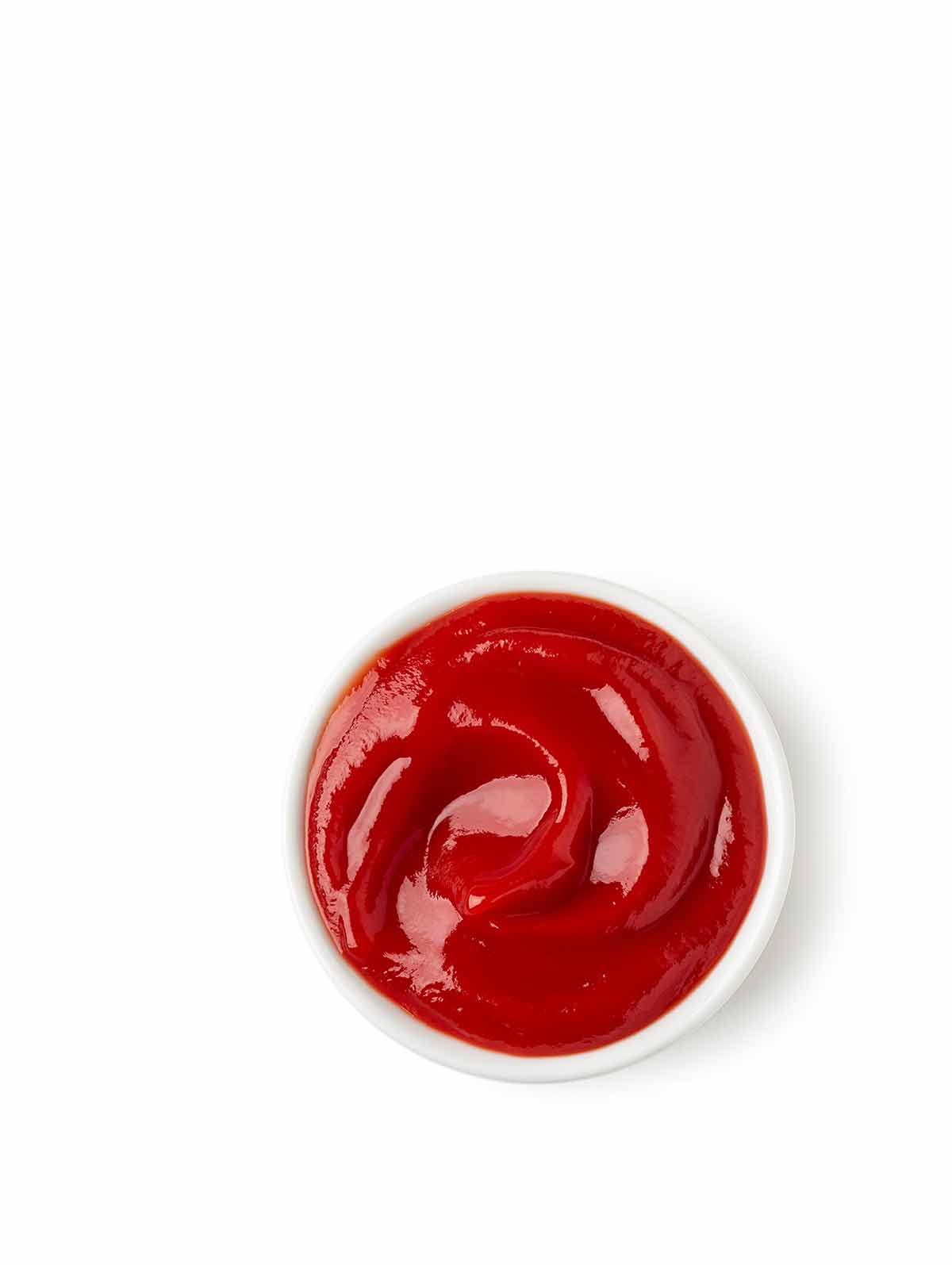 A small white bowl filled with homemade ketchup.