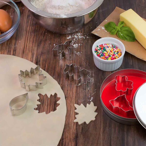 Leaf Shape Cookie Cutters on table with dough and sprinkles.