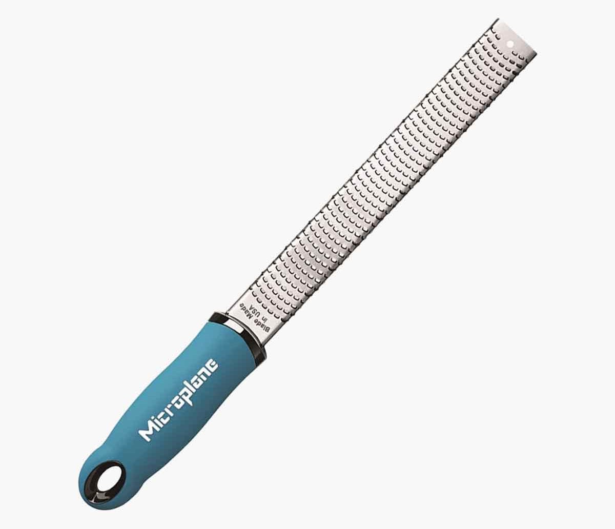 A blue handled Microplane premium classic series zester grater.