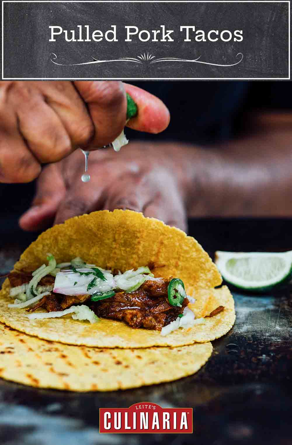 A person squeezing lime juice over an open pulled pork taco.