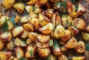 Roasted potatoes with dill on a baking sheet.