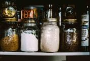 A pantry filled with jars of flour, grains, and spreads to illustrate that stockpiling of food is back.