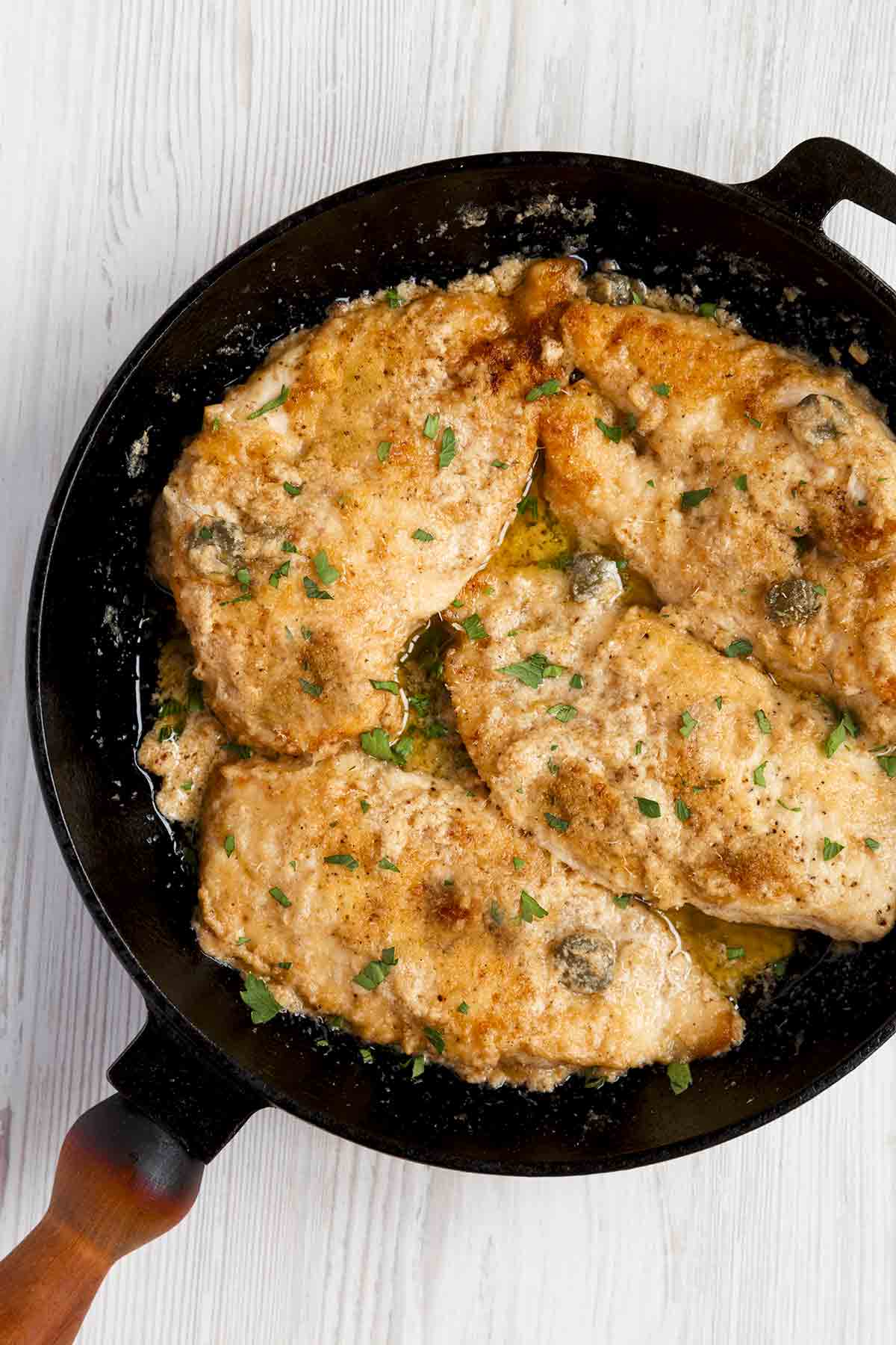 A skillet filled with classic chicken piccata