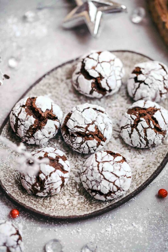 A plate with seven chocolate-ginger crinkle cookies