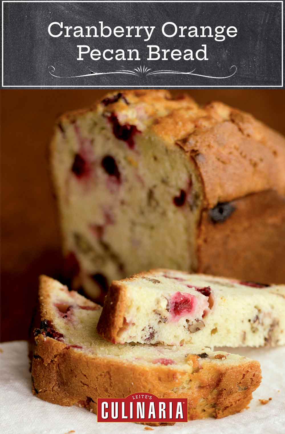 A loaf of cranberry orange pecan bread in the background with a halved slice from it in front