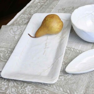 Didonato Floral Linen Table Runner shown with pear on white platter.