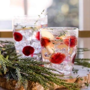 Drop Glass Short Tumbler filled and garnished with thyme.