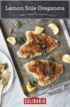 Two fillets of lemon sole oreganata topped with a Parmigiano-Reggiano breadcrumb mixture on a baking sheet