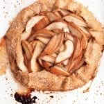 A baked pear galette on a white surface.