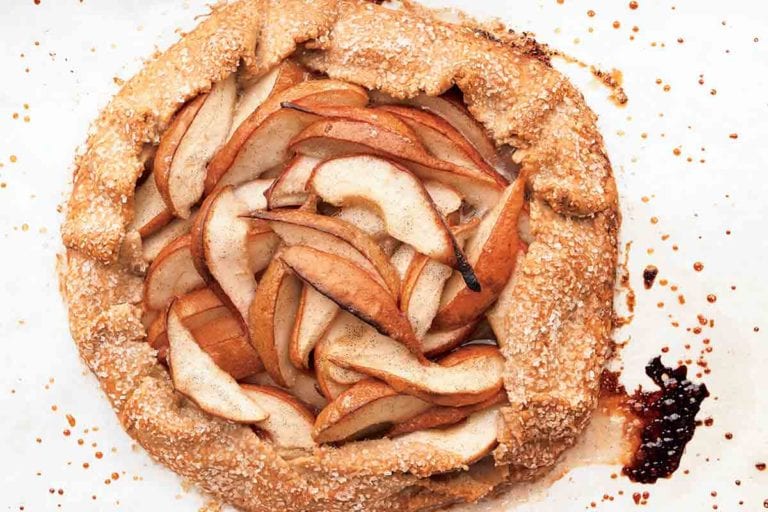 A baked pear galette on a white surface.