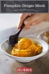 A ceramic bowl filled with pumpkin ginger mash with a person scooping a spoon into it.