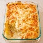 A glass baking dish filled with scalloped potatoes