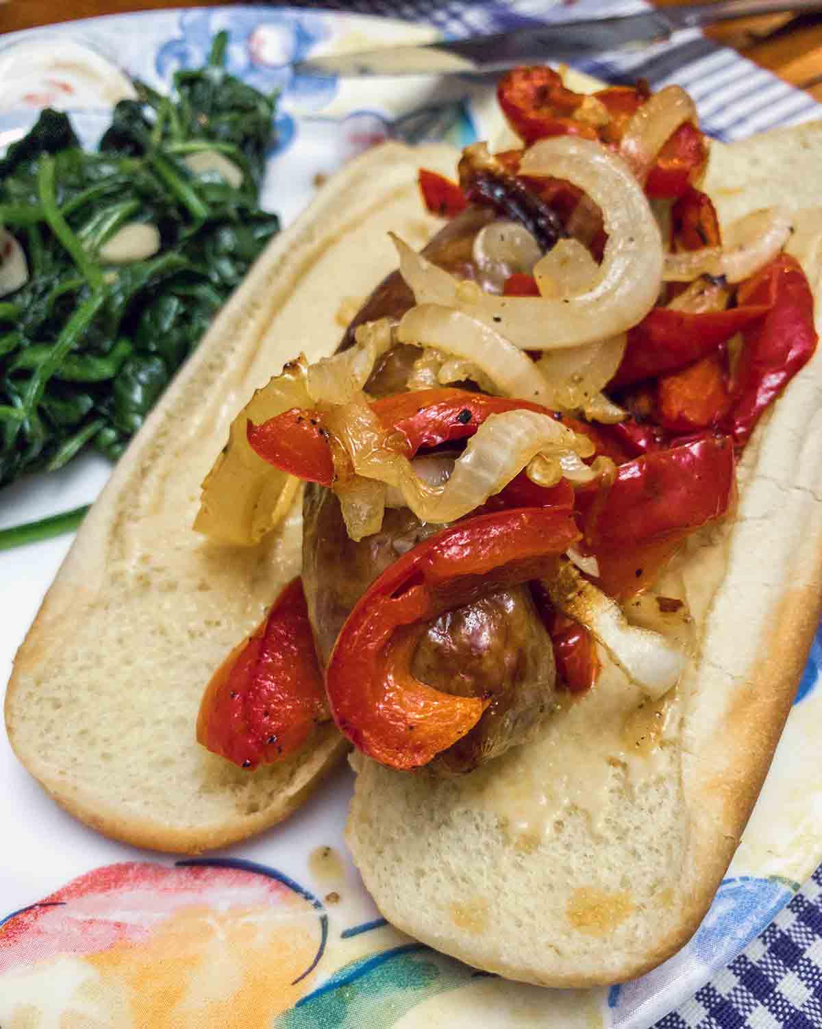 A sheet pan sausage, peppers, and onions on a plate.