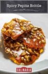 Three pieces of spicy pepita brittle on a white plate.