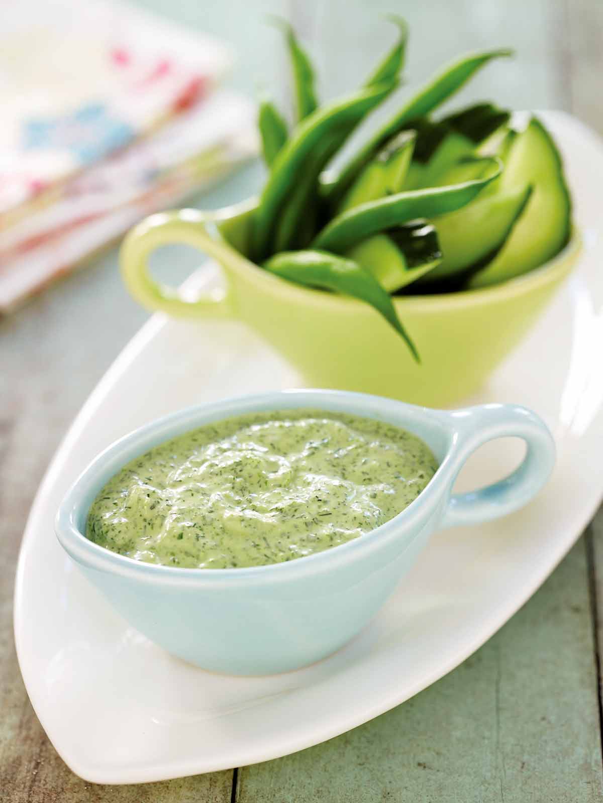 A light-blue gravy boat filled with svelte green goddess dip