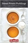 Two sweet potato puddings in white souffle dishes on a silver tray with spoons and a bowl of whipped cream beside them.