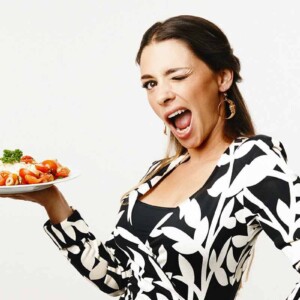 Nadia Caterina Munno, holding a plate of pasta and winking for the podcast Talking With My Mouth Full, Ep. 35: Talking With TikTok's Pasta Queen.
