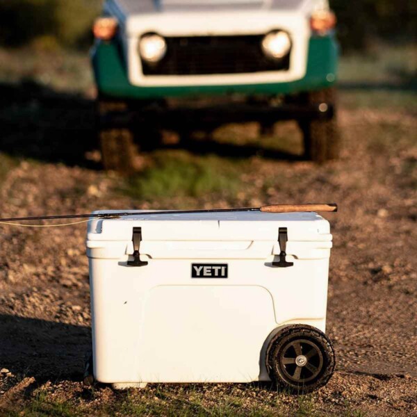 Yeti Tundra Haul Wheeled Cooler in white by SUV.