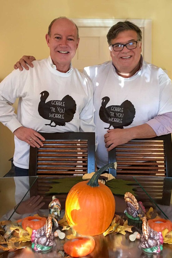 A photograph of David and the One in Thanksgiving t-shirts for the writing "We're Having a Small Thanksgiving and I'm Okay With That"