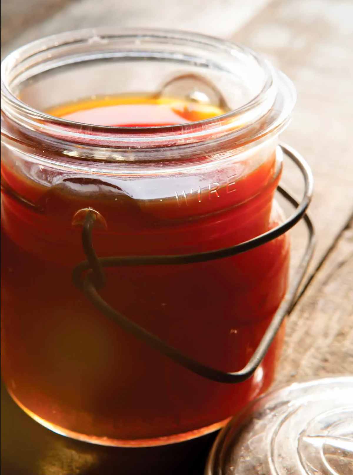 A glass jar filled with beef bone broth.