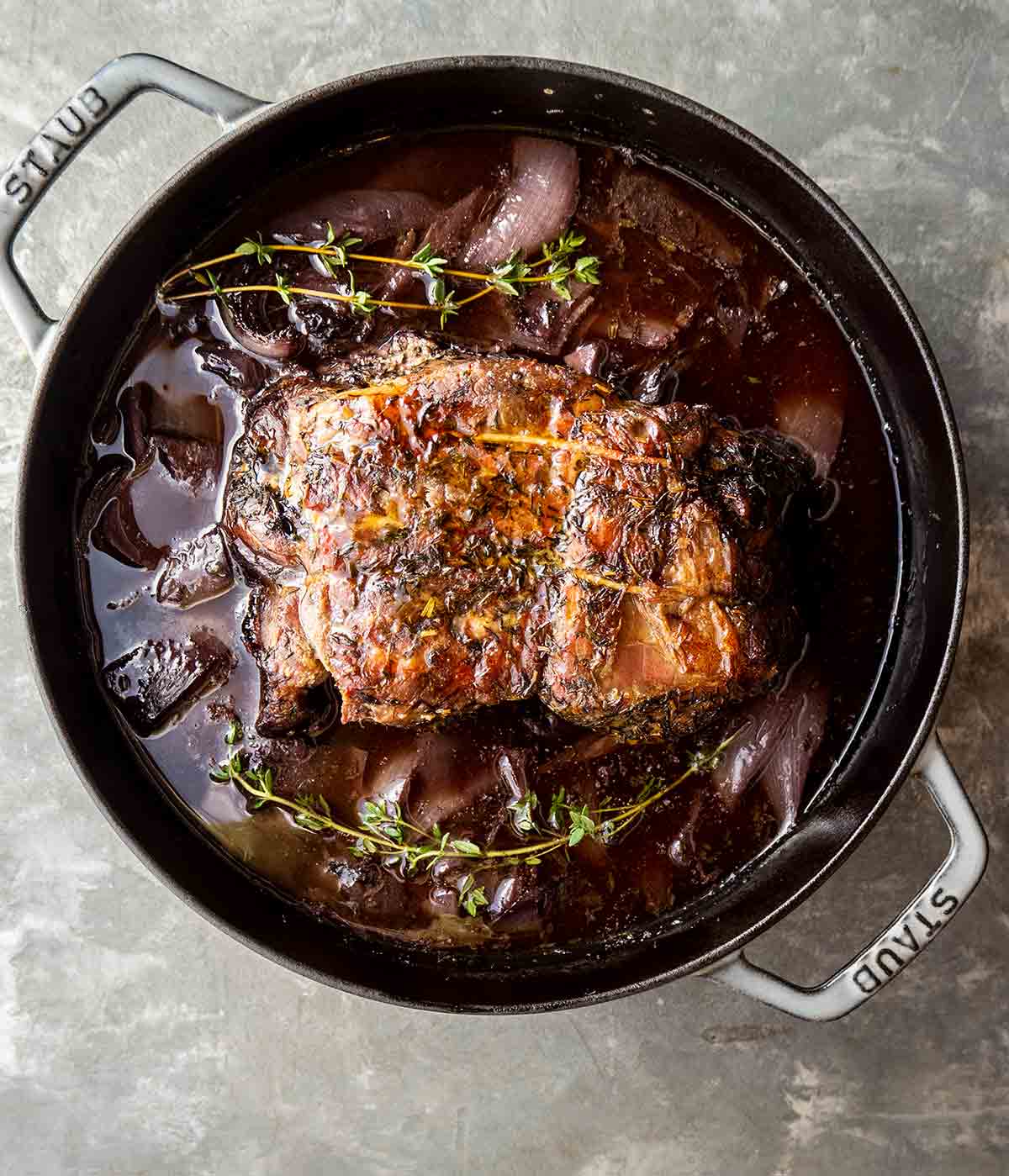 Braised pork with red wine sauce in a Staub Dutch oven.