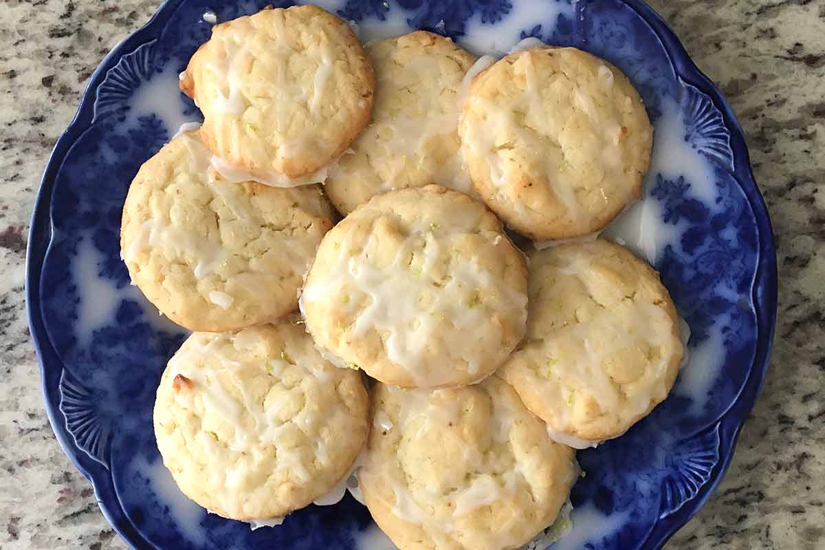 Coconut lime cookies on a blue plate.