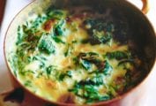 A copper pot filled with creamed spinach.