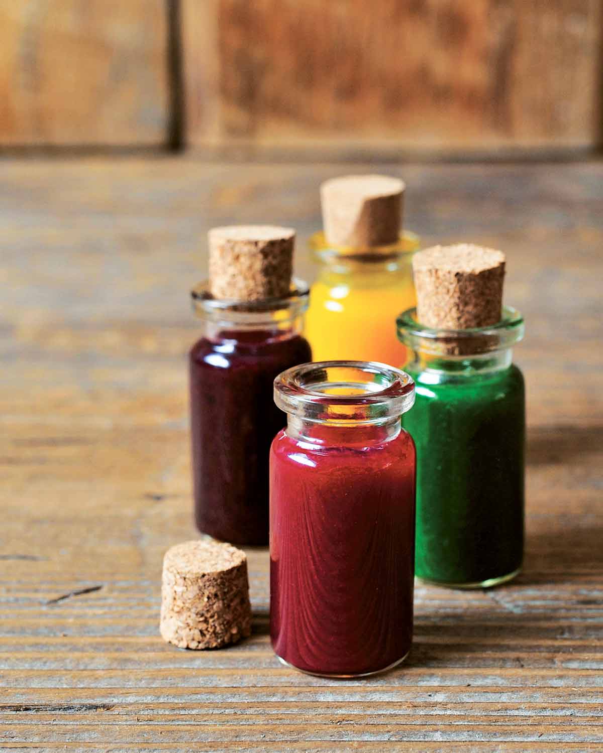 Four bottles of natural food coloring in different shades.