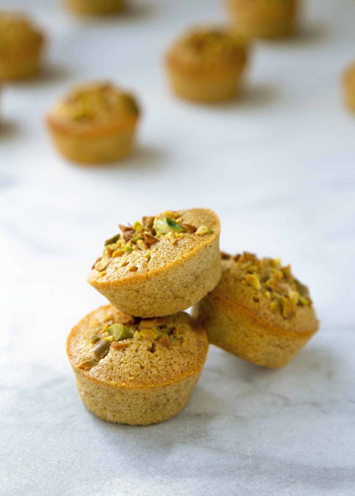 Three Pistachio Financiers stacked on top of each other.