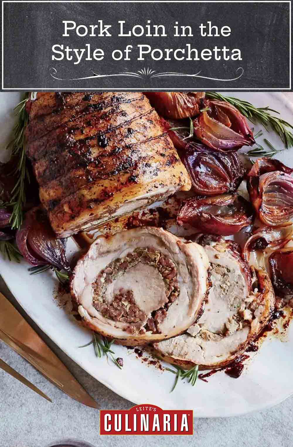 A tied pork loin in the style of Porchetta on a white platter with cooked red onions and rosemary.