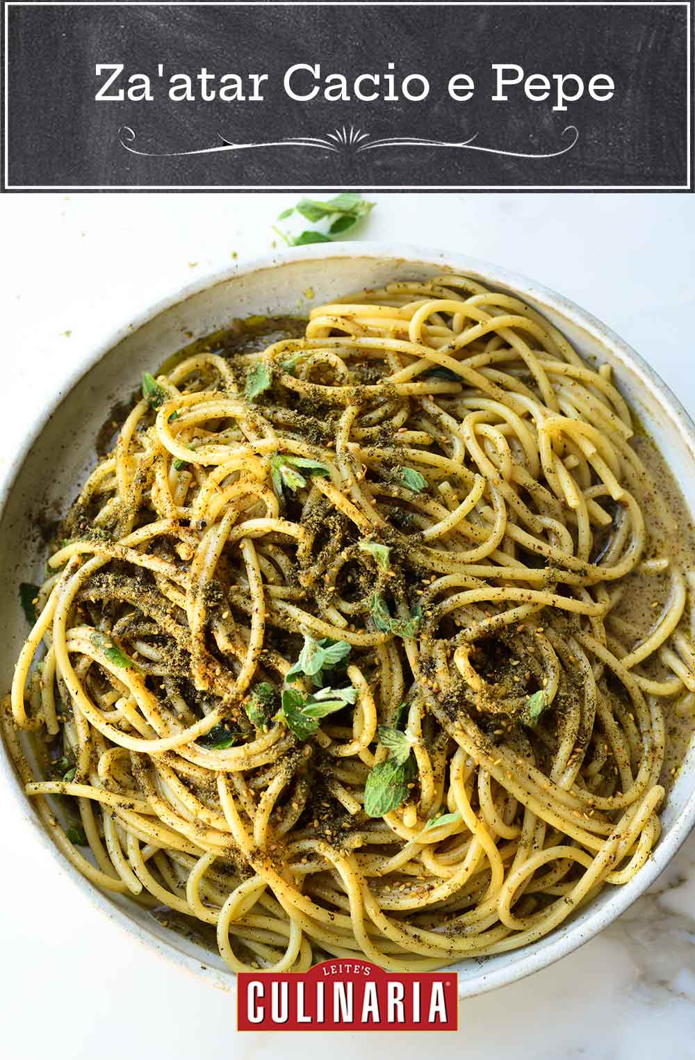A ceramic bowl filled with za'atar cacio e pepe and topped with fresh marjoram leaves.