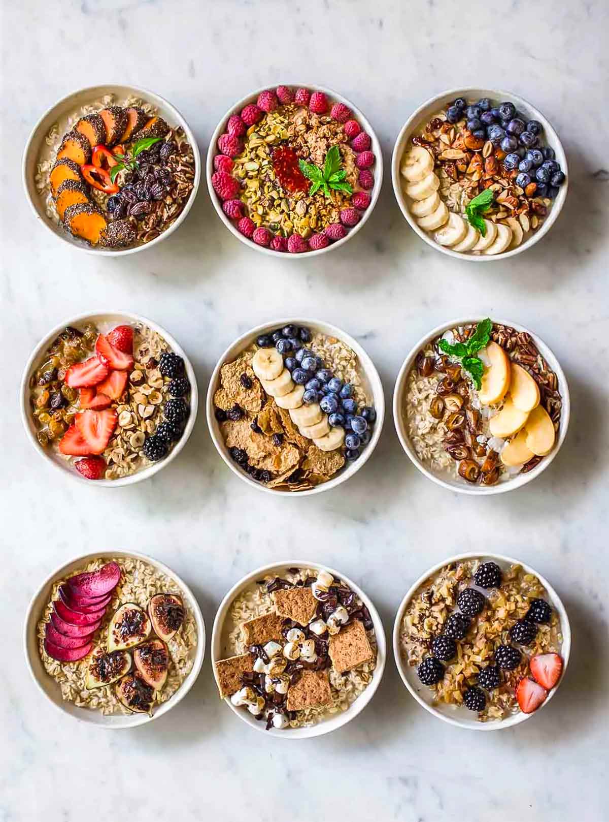 Nine bowls of oatmeal, each topped with different combinations of best oatmeal toppings.