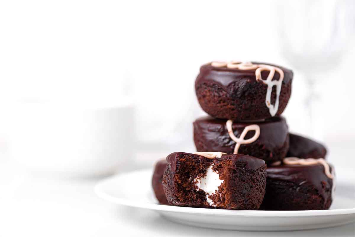 A stack of homemade hostess cupcakes on a white plate.