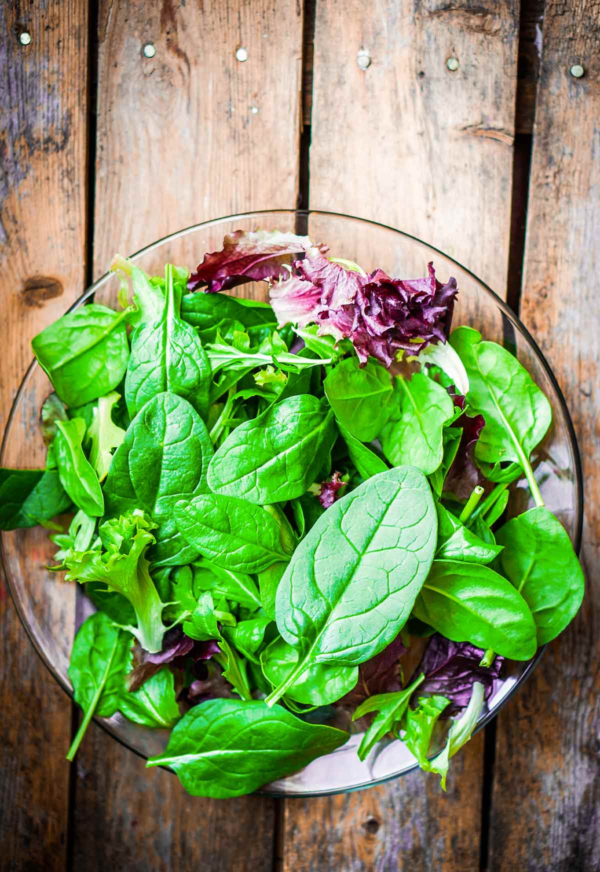 A bowl of mixed salad greens to illustrate how to choose the right salad green for you.