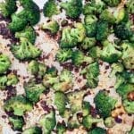 Roasted broccoli with soy sauce scattered on a baking sheet.