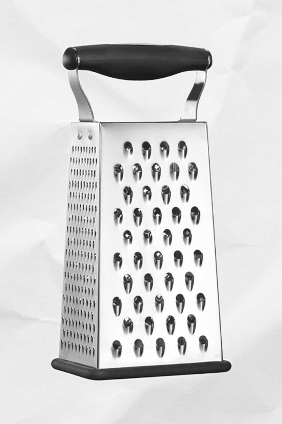 A stainless steel box grater for the writing 'how to use all four sides of your box grater'.