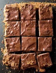 A tray of coconut candy bars cut into squares.
