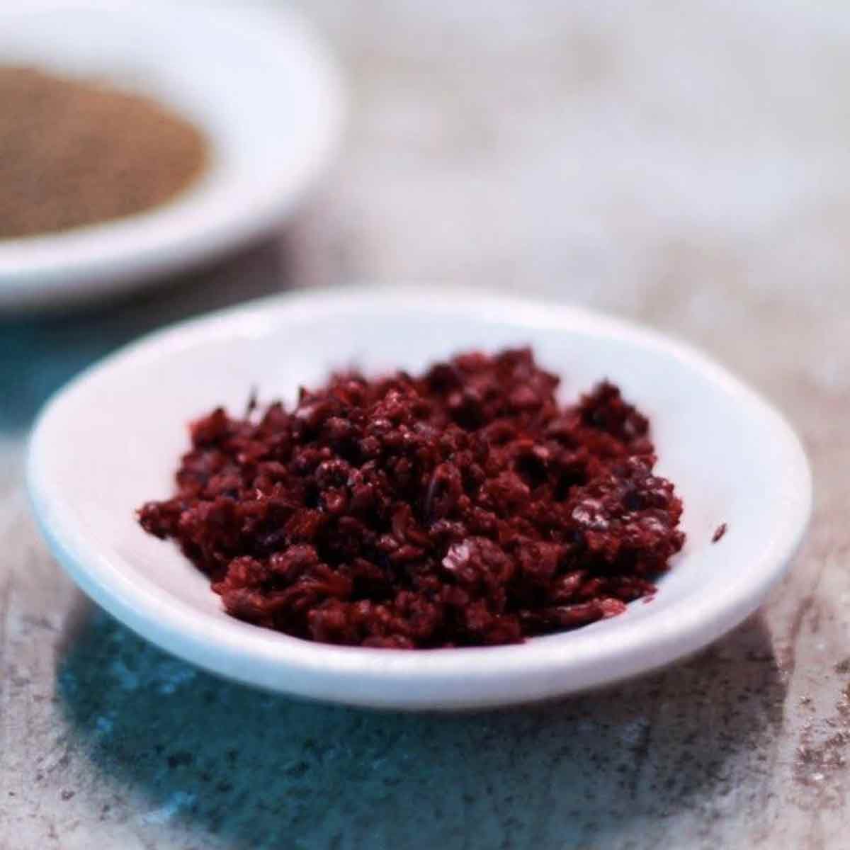 Cured Sumac in white bowl.