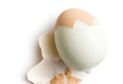 A partially peeled hardboiled egg.