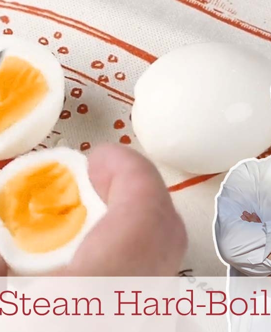 A hard-boiled egg that was steamed being sliced in half.