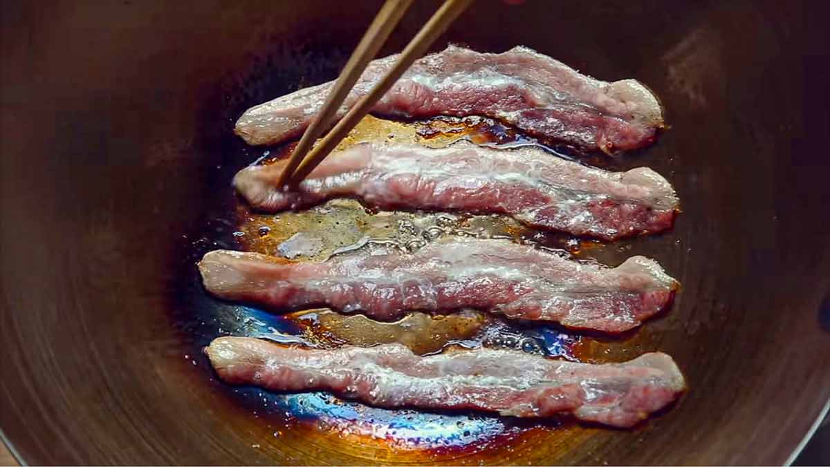 Bacon frying in a wok for the podcast Talking With my Mouth Full, Ep. 39: Everything Wok with Grace Young.