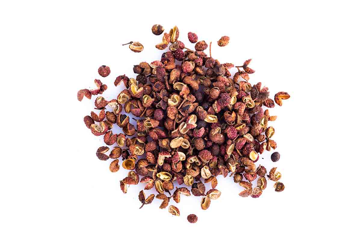 A pile of Sichuan peppercorns on a white background.